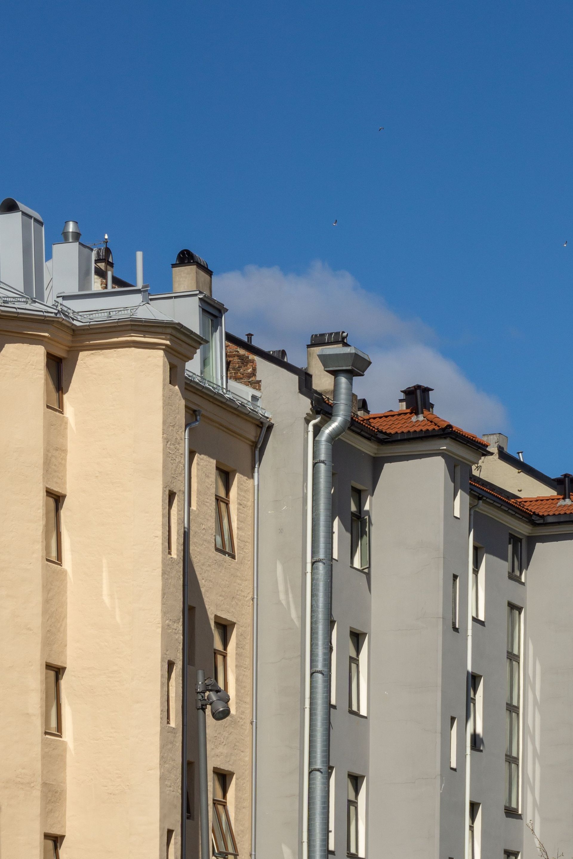 Colorful residential buildings in Oslo under a clear blue sky, showcasing urban architecture.