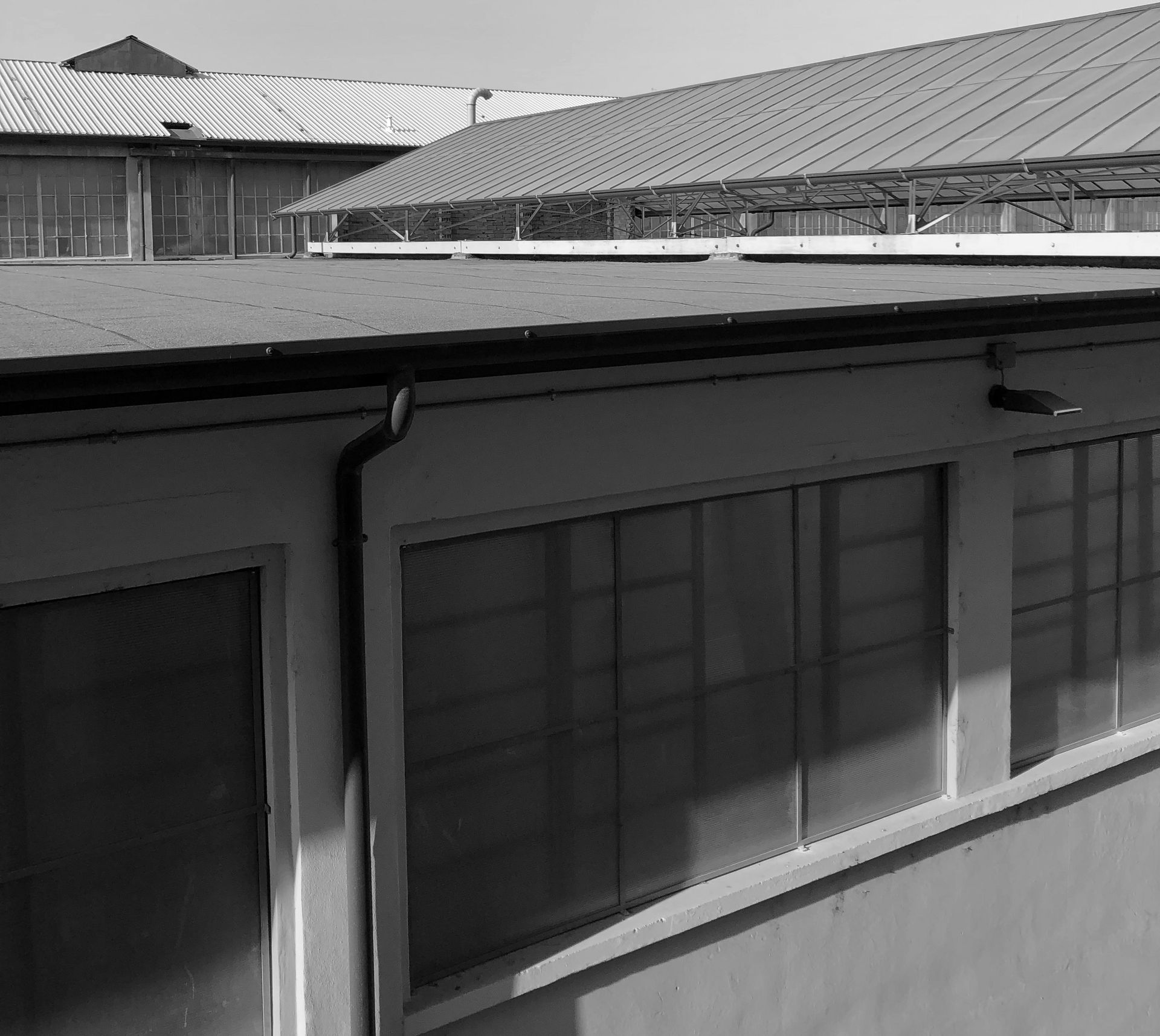a black and white photo of a building with a roof